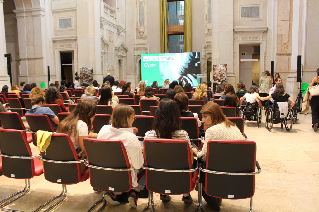 Imagem de uma conferência com várias pessoas sentadas.